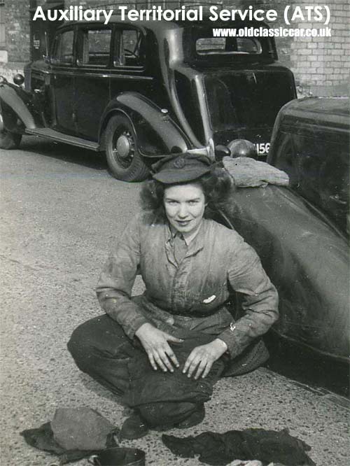 A female ATS mechanic works on a military vehicle