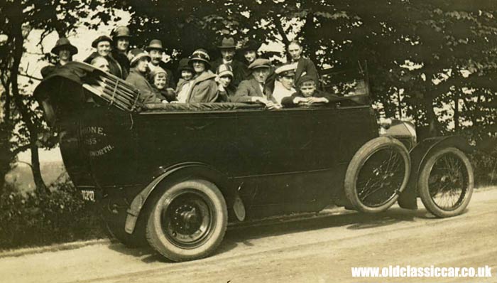 A 1920s charabanc parked at the roadside