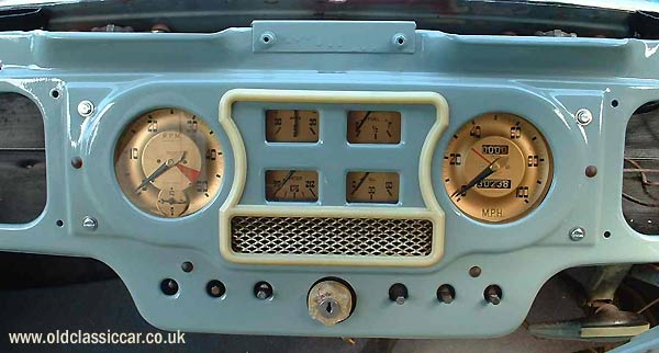 The freshly painted dashboard with original gauges and switches in place