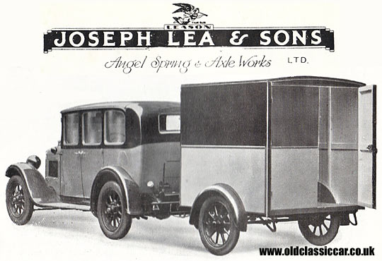 A vintage car towing a Leason trailer