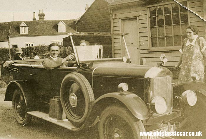 A vintage Singer Ten with its driver behind the wheel