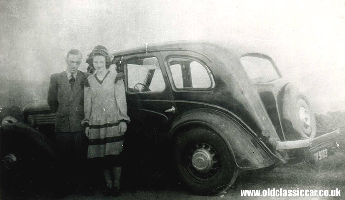 Two people and a Wolseley car