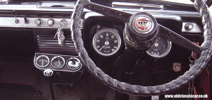 A Ford 107E dashboard fitted with three extra gauges