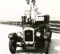 Vintage Austin saloon car with its owners