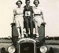 Three people and a vintage Austin motor-car