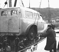 An A40 being loaded onto a ship in the 1950s