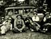 Men sat around some old cars