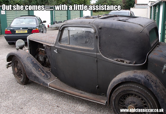 Towing the classic Daimler car from its garage
