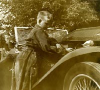 Another view of the boy working under the MG's bonnet