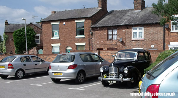 Old car parked with newer models