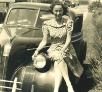 Young lady sat on a classic Pontiac car