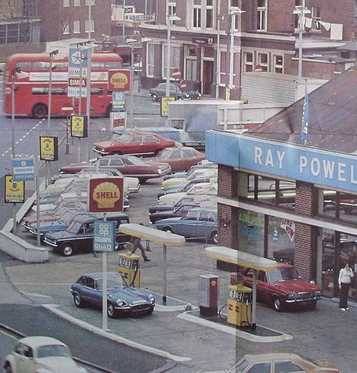Hillmans, a Jaguar E-Type and other cars outside this 1970s garage