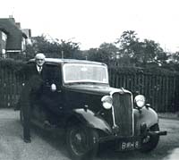 A man stood with his Singer 11 car