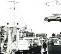 Loading a car onto a ship by crane
