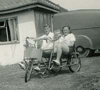 A pedal tricycle outside a holiday cottage/chalet