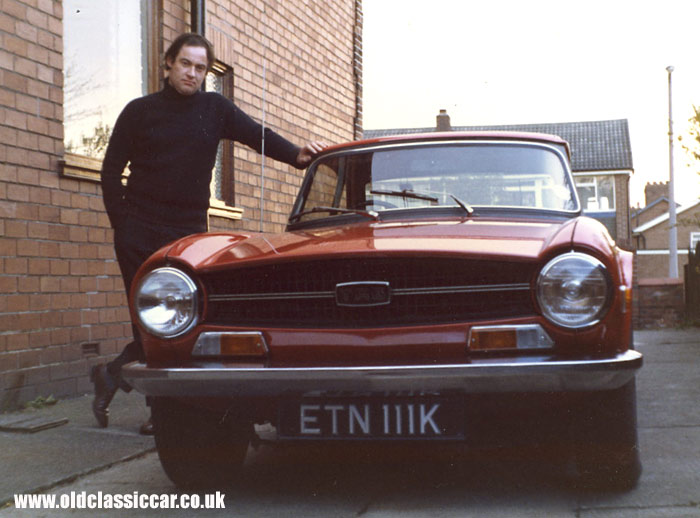 A bright red Triumph TR6 car