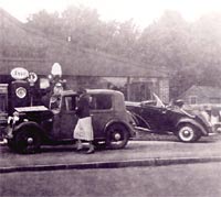 Prefect drop-head coupe outside a garage