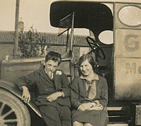Two people sat on a van's step