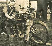 A gent sat on a dismantled motorcycle