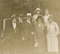 Another faded photo of people and cars