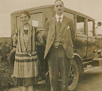 Two people with a vintage car