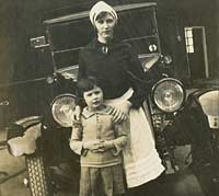 A nurse with child, in front of a taxi