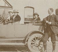 The vicar leans against a 1920s touring car