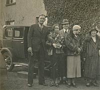 Men and women with a 1920s car