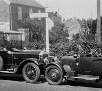 A Rover parked facing an elderly Wolseley