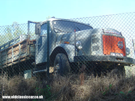 A bonneted Volvo commercial shown at rest alongside a Portuguese main road.