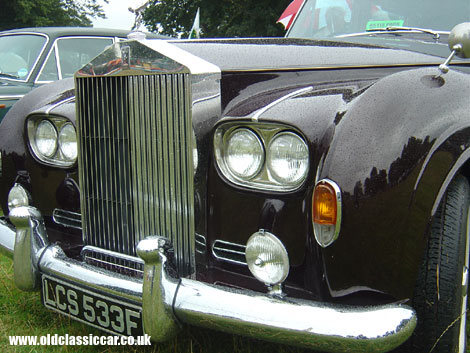 A late-sixties' Rolls-Royce gets caught in a shower at Astle Park.