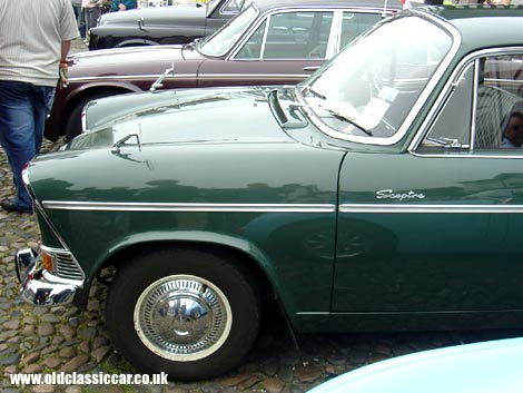 A Humber Sceptre of the early 1960s joins a Series 2 XJ6 on a cobbled town square.