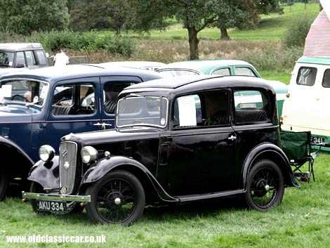 A black Mk1 Austin Ruby rubs shoulders with a larger Austin of similar age.