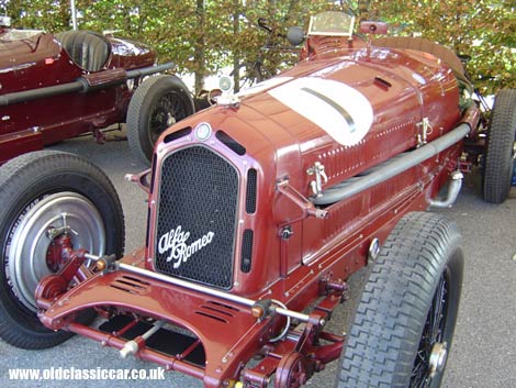 Two glorious Alfa Romeo GP cars at a Goodwood event.