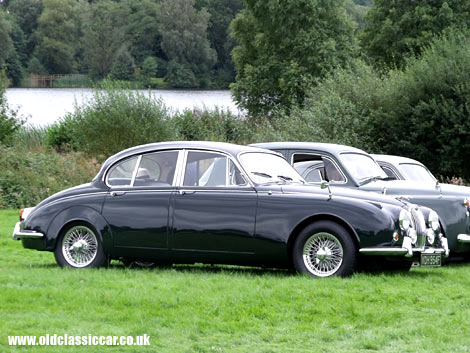 A Jaguar 240/340 saloon parked alongside a '50s Rover.